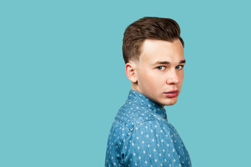 Fototapeta premium serious young guy portrait dressed in black t shirt looking at the camera