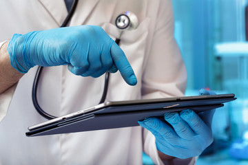 Hands doctor using software in digital tablet in the laboratory