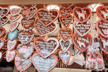 Gingerbread Hearts at the German Christmas Market. Traditional gingerbread with different inscriptions in German at a fair in Germany