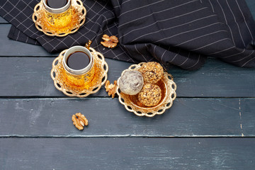 Nut balls dessert served with coffee on dark wooden table, top view