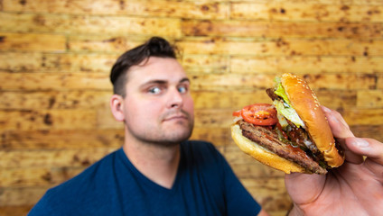 Happy man with his fast food burger. Not so much healthy life style, but whatever!