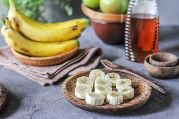 Photo of whole and sliced bananas on retro background. Healthy breakfast. Yellow fruit. Tropical fruit. Ready to eat. 
