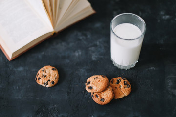 Glass with fresh milk and chocolate chips cookies.  Oatmeal cookies  and glass of milk for...