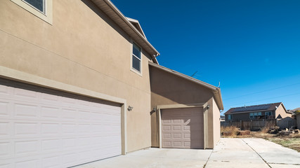 Panorama Concrete forecourt with closed garage doors on a sunny day © Jason