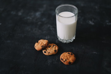 Glass with fresh milk and chocolate chips cookies.  Oatmeal cookies  and glass of milk for breakfast. Healthy good morning