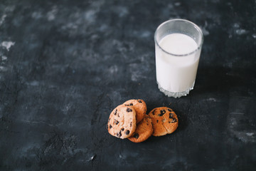 Glass with fresh milk and chocolate chips cookies.  Oatmeal cookies  and glass of milk for breakfast. Healthy good morning