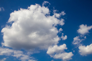 white fluffy clouds on a background of blue sky