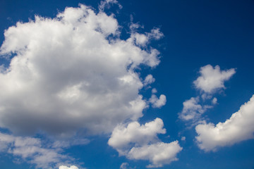 Naklejka na ściany i meble white fluffy clouds on a background of blue sky