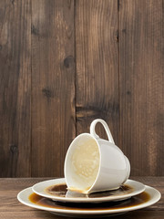 Cup spilled coffee wooden background