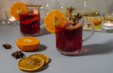 Glintwein in glassware and set for making a drink on a blue surface.