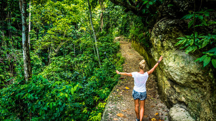 Girl on the path making selfy leading fromTembeling pool, Nusa Penida Bali Indonesia