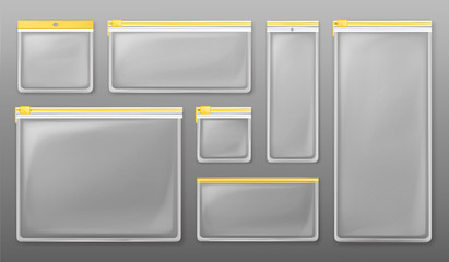 Transparent plastic zipper bags isolated on gray background. Vector set of empty clear pockets sealed by yellow ziplock. Realistic mockup of different size packets © vectorpocket