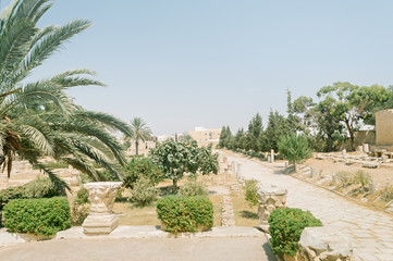 The Scenic garden with the capitals of the ancient columns in the courtyard of the archaeological museum of El Jem, Tunisia