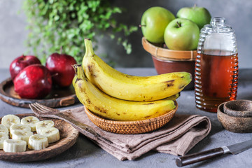Photo of fresh raw banana bunch on table. Healthy food. Peeled cut bananas. Vegetables. Raw organic fruit. Slice. Photo.