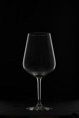 Empty glass, crystal glass on a dark background for white and red wine. Vertical