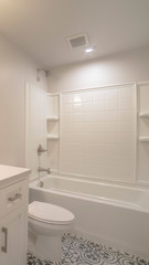Fototapeta na wymiar Vertical frame Modern fitted white bathroom interior of home