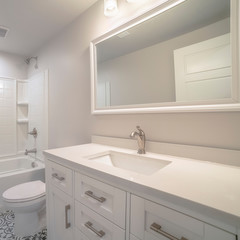 Obraz na płótnie Canvas Square Modern fitted white bathroom interior of home