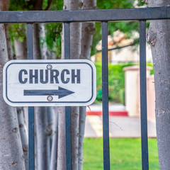 Square Church sign pointing to the right on a sunny day