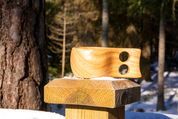 Wooden kuksa with tea in winter forest, Espoo, Finland