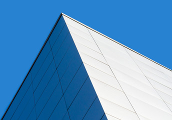 Fototapeta na wymiar fragment corner of a modern building on a blue background