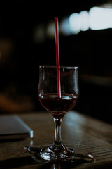Glass of alcoholic cocktail on the bar counter in the night club