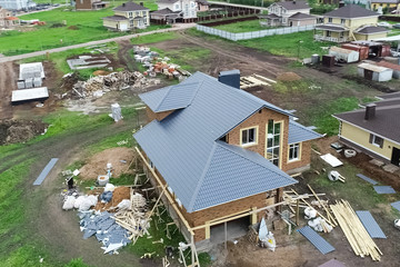 Holiday village, view from above. House with a new roof made of