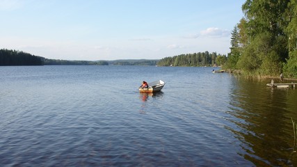Fototapeta na wymiar Boy in boat on lake