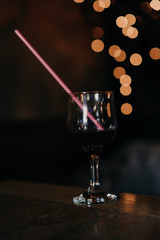 Glass of alcoholic cocktail on the bar counter in the night club