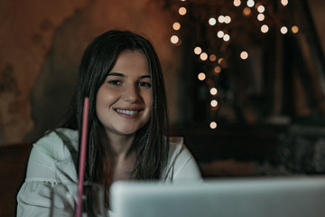 Beautiful woman working on laptop in bar