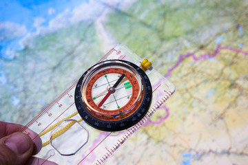 Compass in hand on a map background.