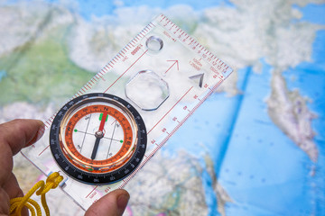 Compass in hand on a map background.