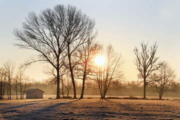Frosty sunrise on the prairie with the house