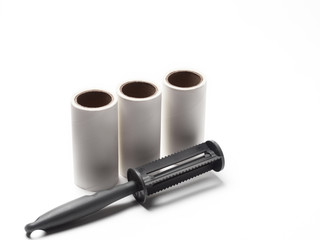 Cleaning roller, holder and spare tape for cleaning clothes or fabric from animal hair or fur. Isolated white background