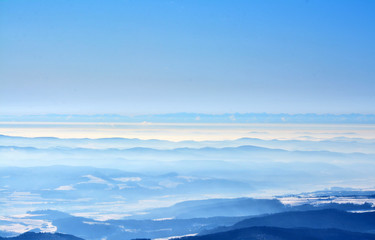 Fototapeta na wymiar the peaks of the mountains seen through the fog