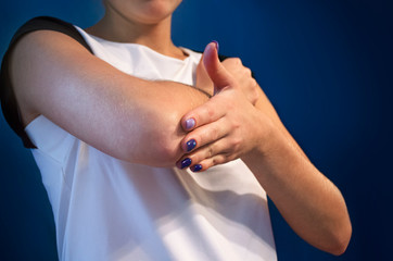 Pain in the elbow. The girl holds