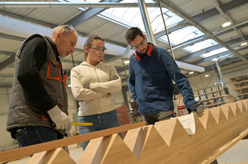 Fototapeta premium Young people in job training in carpentry workshop