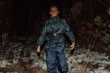 Obraz premium Male hikers in clothes for hiking and flashlights on winter mountain at night.