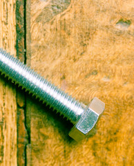 Close up of M8 bolt isolated on wooden background