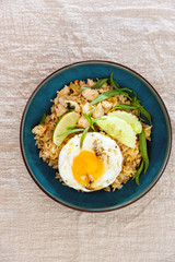 Wok rice cooked with soy sauce, vegetables and chicken pieces.