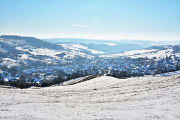 a village between hills in winter