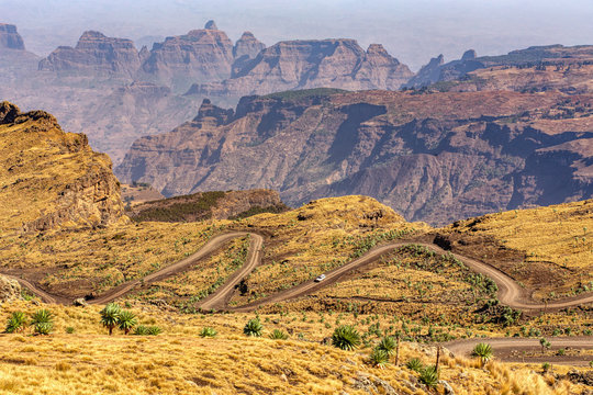 Stony winding road in Semien or Simien Mountains National Park landscape in Northern Ethiopia. Africa wilderness, Sunny morning with blue sky