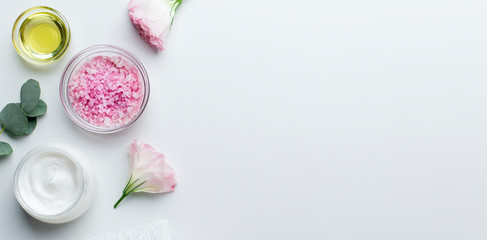 Fototapeta na wymiar Cosmetic products in jars of rose petals and pink salt