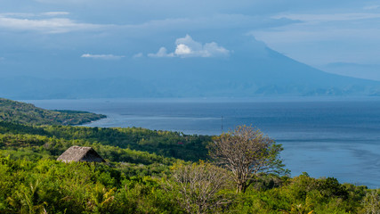 Beautifull evening view to St. Agung Vulcano on Bali from Nusa Penida Island. Partly Covered by Clouds. Indonesia
