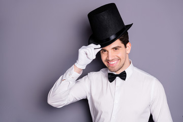 Close up photo of positive cheerful magician man ready entertain audience touch hands black hat...