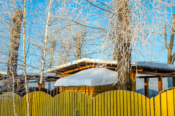 House in the village in winter under the snow.Construction of wood on a frosty day.