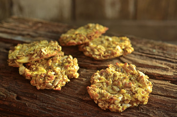 Fresh oat cookies with apples on a wooden background