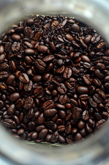 Fresh coffee beans in a glass jar