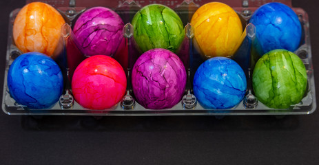 Plastic bowl full of colourful Easter eggs