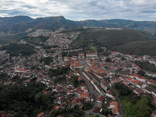 Wide view of colonial mining city centre Ouro Preto in Minas Gerais, Brazil, with surrounding mountains in the background seen from a high vantage point