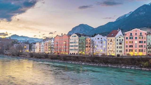 Time lapse of colorful buildings and river of Innsbruck, Austria during a winter sunset